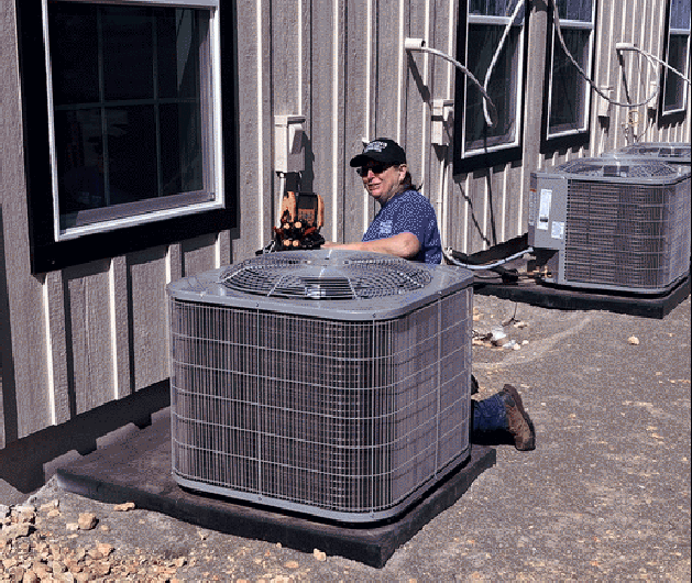 Technician working on HVAC equipment